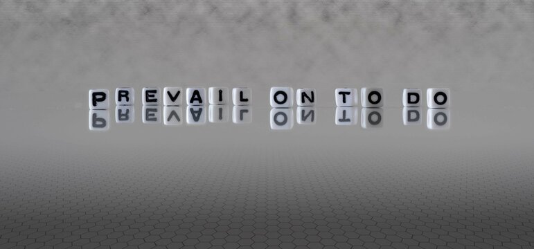 prevail on to do word or concept represented by black and white letter cubes on a grey horizon background stretching to infinity