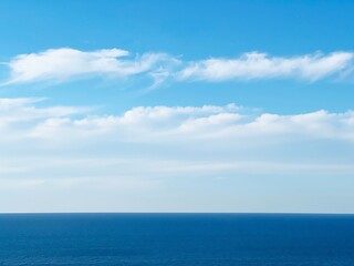 Naklejka na ściany i meble Blue sea water and sky clouds.