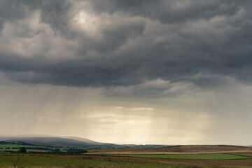 Naklejka na ściany i meble Thunder clouds over Northumberland countryside