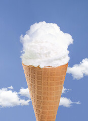 Refreshing ice cream cloud with crispy waffle cone on blue sky background