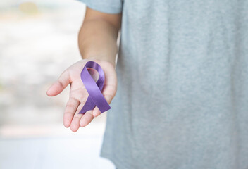 Purple ribbon in hold hand.