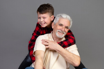Close up loving grandfather and little grandson enjoying tender moment 