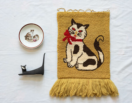 Mid-century modern carpet with a strange cat and two decorative object
