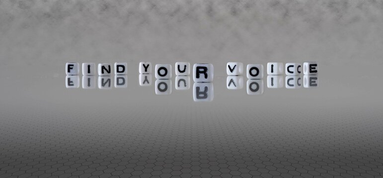 find your voice word or concept represented by black and white letter cubes on a grey horizon background stretching to infinity