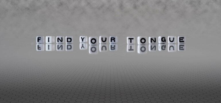 find your tongue word or concept represented by black and white letter cubes on a grey horizon background stretching to infinity