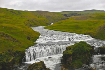 Fototapeta premium river among green meadows of iceland