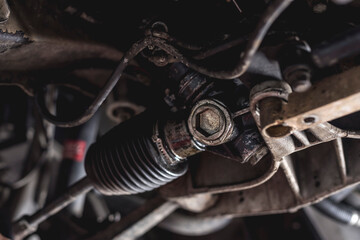 Closeup of a steering rack nut of a car. - obrazy, fototapety, plakaty