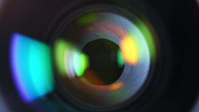 Close-up aperture blades inside of professional camera lens with color reflections. High quality 4k footage