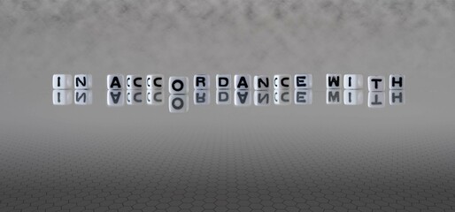 in accordance with word or concept represented by black and white letter cubes on a grey horizon...