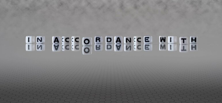 in accordance with word or concept represented by black and white letter cubes on a grey horizon background stretching to infinity