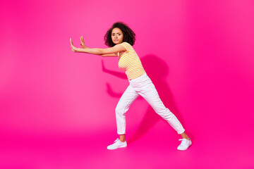 Full size photo of young attractive nice girl push hard difficult abstract empty space object serious isolated on pink color background