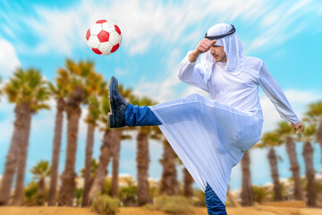 arab businessman playing with a soccer ball in the desert with palms