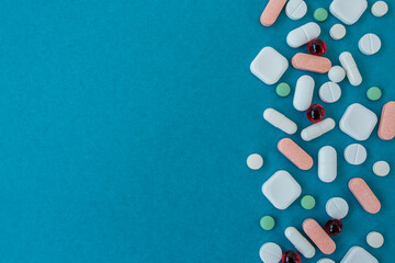 Many different pills on blue background. Copy space. Top view. Top view. Concept of pharmaceuticals, medicine