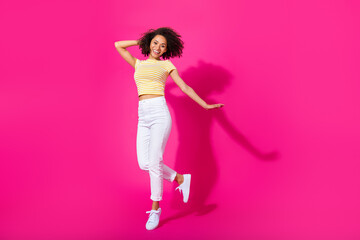 Full size photo of gorgeous young lady posing clubbing dance wear trendy yellow striped garment isolated on bright pink color background