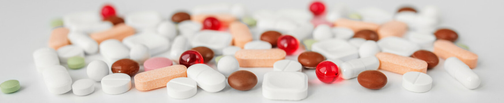 Many different pills on white background. Copy space. Concept of pharmaceuticals, medicine. Banner
