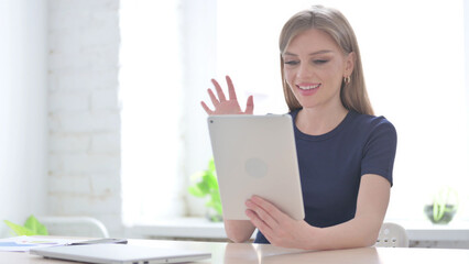 Woman making Video Call on Tablet in Office