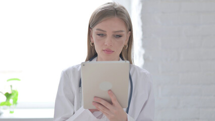 Portrait of Lady Doctor using Tablet in Office