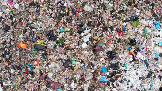 Drones are flying over large garbage pile of plastic waste, garbage, dump. Plastic pollution crisis. Global damage environmental concept. 4k
