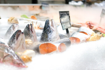 Refrigerated showcase with salmon in the store. Chilled red fish is sold in the supermarket.