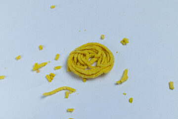 Kerupuk Mie or Noodle Crackers, which are messy on a white background, are a typical Indonesian...