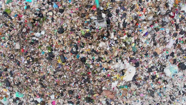 Aerial view from a drone flying over a large pile of garbage,  Lots of plastic bottles and plastic waste. environmental Issues. household waste. global problem. 4k
