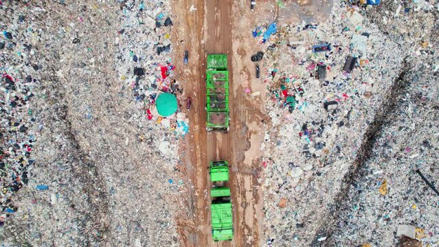 4K : Aerial view from drone flying over large landfill, Lots of plastic waste and compostable waste. garbage background. environment protection. ecological catastrophe
