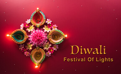 Happy Diwali - Clay Diya lamps lit during Diwali, Hindu festival of lights celebration. Colorful traditional oil lamp diya on red background