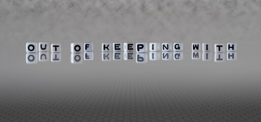 out of keeping with word or concept represented by black and white letter cubes on a grey horizon...