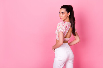 Rear behind photo of adorable indonesian lady posing empty space isolated on pink color background