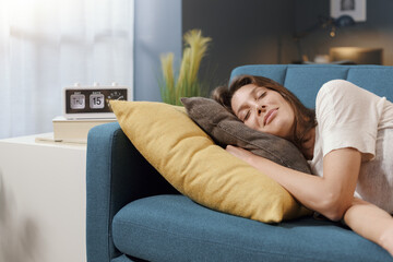 Relaxed woman sleeping on the sofa at home