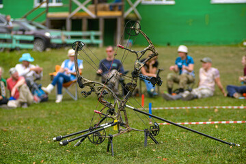 professional archer shooting with modern longbow in forest