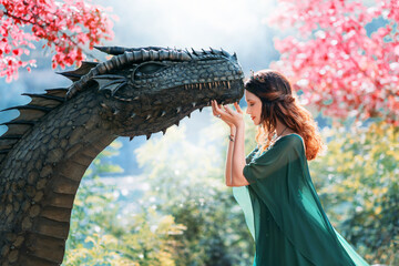 Fantasy female queen hugs and touches pet dragon with love like mother. Magic divine sun light...