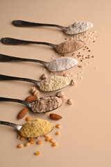 Gluten free text and spoons of various gluten free flour. Flat lay, top.
