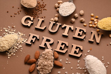 Gluten free text and spoons of various gluten free flour. Flat lay, top.