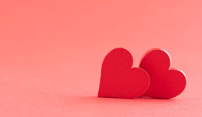 Fototapeta premium Hearts of fabric on a pink background. Time for lovers' day, Valentine's day.