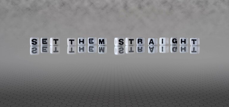 set them straight word or concept represented by black and white letter cubes on a grey horizon background stretching to infinity