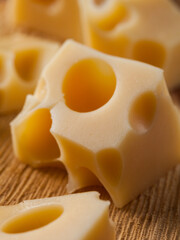 Pieces of Cheese on rustic wooden background