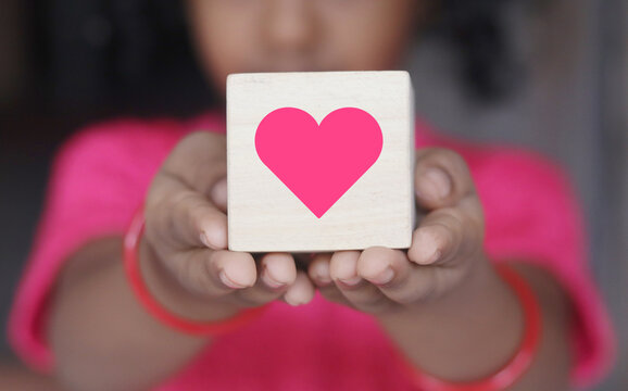 Kids Hand Holding Pink Heart on Wooden block, Holding Heart,  Indian girl holding, Asian Kids, Care Concept Showing as Icons Heart