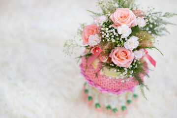 A bouquet of pink flowers placed on a white background, focusing on the white flowers, leaving the copy space.