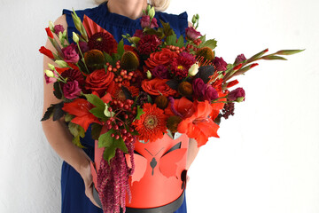 Beautiful flowers for holiday. Woman with beautiful flowers in  hands indoors background.  bouquet of flowers for  flower shop.