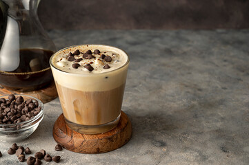 Coffee and vanilla ice crem with chocolate , coffee beans in glass cup, copy space. Lisestyle iced coffee drink.