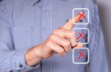 Man choosing wrong answer at digital screen with cross. Businessman taking examination, survey,...
