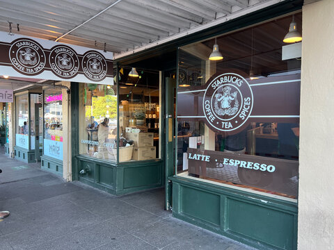 SEATTLE, WA - September 2022: Entrance and Store window of "The first ever Starbucks Coffee Shop" in USA, locate at Pike Place Market. Seattle is the largest city in both Washington State