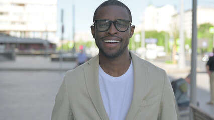 Obraz premium Portrait of African Man Smiling at Camera Outdoor