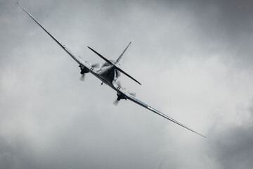 Old classic airplane in the sky with dark clouds