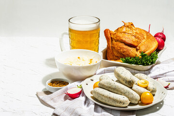 Traditional Oktoberfest set. Beer, weisswurst, smoked pork knuckle eisbein with fermented cabbage