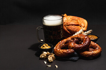 Traditional Oktoberfest set. Pretzels, beer, smoked pork knuckle eisbein with mustard