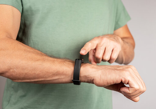 Man wearing fitness tracker and checking physical activity results. Heart rate measurement, steps number counting. Healthy lifestyle concept.