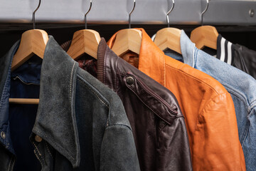 Various vintage jackets on clothing rack in second hand store