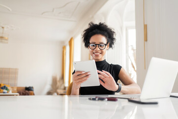 A female freelancer career in the company, makes an online report in the office on the project. Uses a computer in the new office.